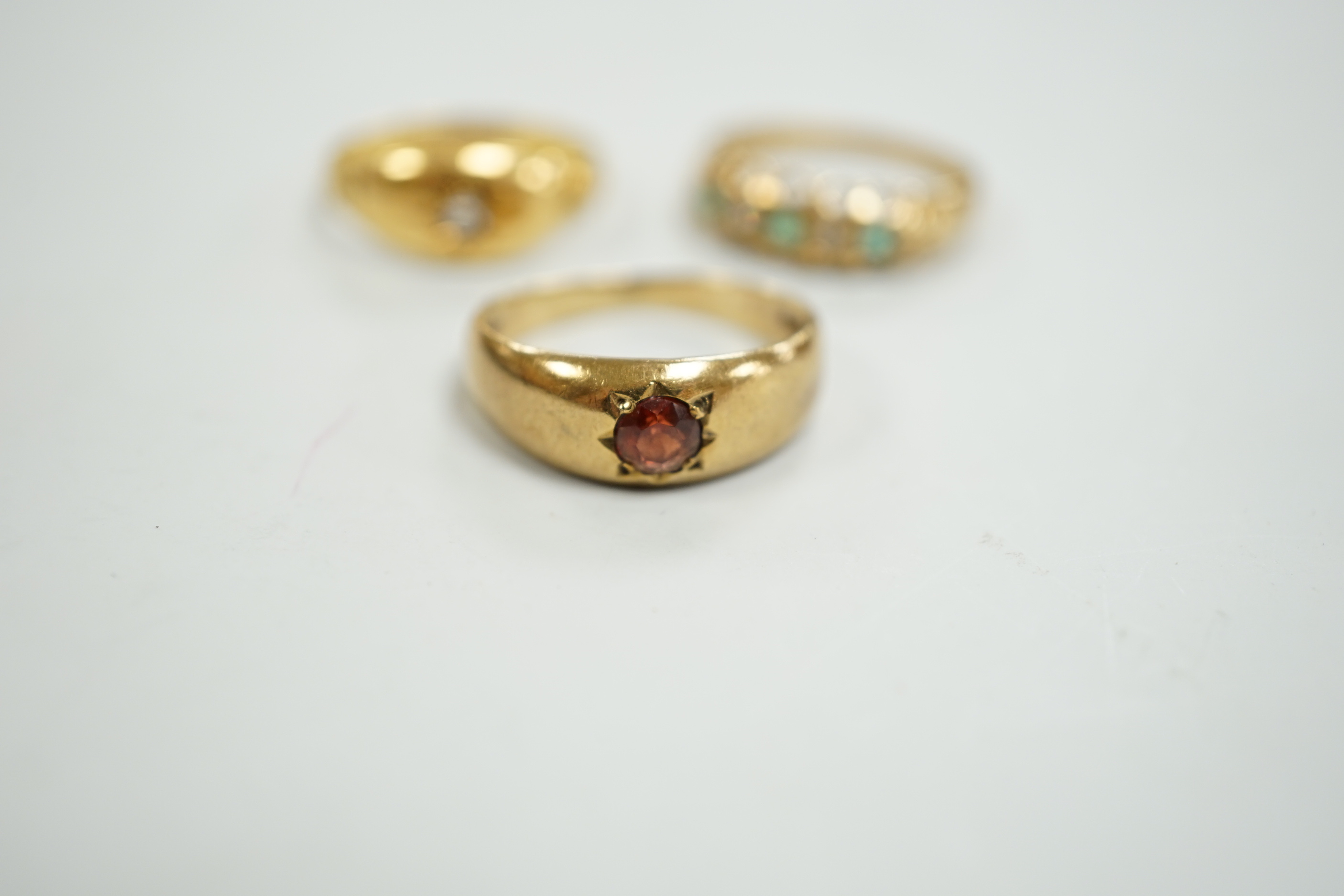 An Edwardian 18ct gold and diamond chip set ring, size M, gross weight 2.6 grams and two later 9ct gold and gem set rings, gross weight 5.5 grams.
